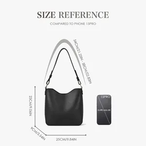 Minimalist black leather bucket messenger bag size guide with Phone 15 Pro scale