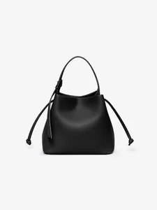 Macro detail of high-quality lychee pattern black PU leather on a bucket handbag
