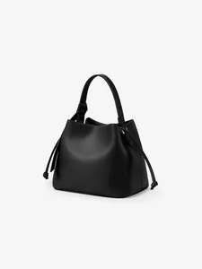 Detail view of the black pebbled leather bucket bag showing side drawstrings and top handle
