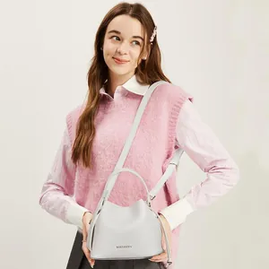 Detail of light grey lychee pattern leather bucket bag with BOSTANTEN logo and strap