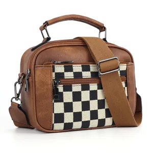 Brown faux leather crossbody bag with black and white checkerboard canvas panel