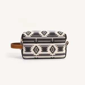Detail of bohemian geometric pattern PU leather toiletry bag with brown wristlet strap