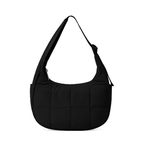 Detailed view of the black quilted nylon crescent bag with textured grid patterns