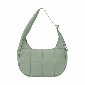 Detail of light green quilted nylon shoulder bag showing puffy square stitching and zipper