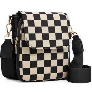 Close-up of checkerboard mini crossbody bag with gold hardware and adjustable strap