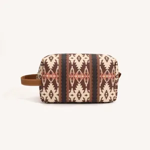 Detail of bohemian toiletry bag with brown geometric tribal pattern and leather handle