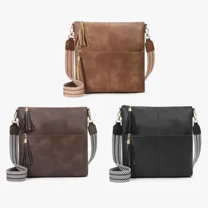 Three vintage crossbody bags in brown and black with wide geometric striped straps