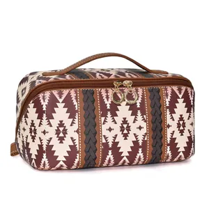 Close-up of bohemian geometric print toiletry bag with textured leather and gold zippers