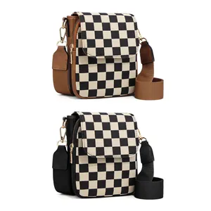 Detail of checkered crossbody phone bags with adjustable straps and golden hardware