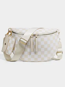 Detail of checkered crossbody bag with detachable pouch and golden hardware accents