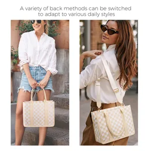 Detail of checkered tote bag showing adjustable wide shoulder strap and gold hardware