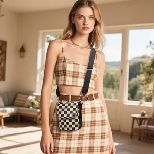 Checkerboard mini crossbody phone bag with adjustable wide strap shown on a model