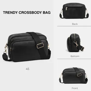 Detailed views of black textured faux leather crossbody bag with dual gold zippers