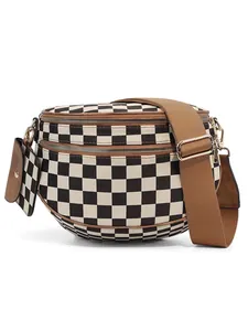 Detail of checkered crossbody bag with wide brown strap and mini coin purse attachment