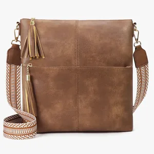 Brown vintage faux leather crossbody bag with cross-stitch pattern and woven shoulder strap