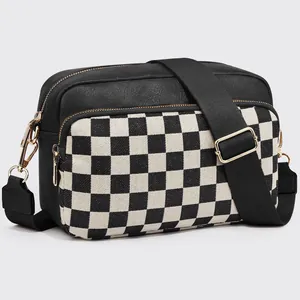 Detail of checkered crossbody bag with adjustable wide strap and gold metal hardware