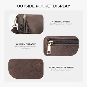 Detail of vintage brown textured leather bag with gold hardware and stylish tassels
