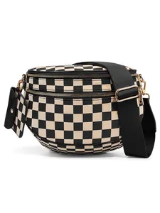 Detail of checkered crossbody shell bag with dual zippers and matching coin purse charm