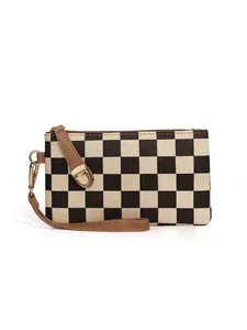 Close-up of checkerboard clutch bag with brown leather wristlet and gold hardware