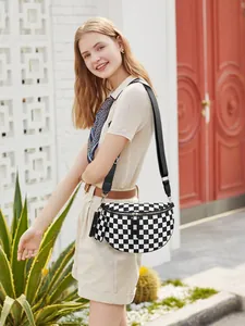 Detail view of checkerboard fanny pack with a detachable matching mini earphone pouch