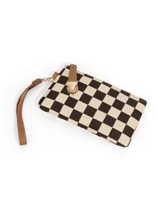 Detail view of the vintage checkerboard wallet showing the wrist strap and golden buckle