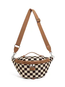 Close-up of checkerboard canvas chest bag with brown trim and silver metal zipper detail