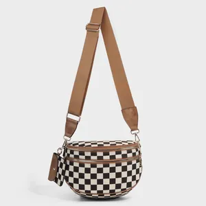 Black and white checkerboard crossbody shell bag with double zippers and wide strap