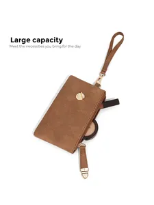 Close-up of brown textured leather wristlet showing large capacity for cosmetics