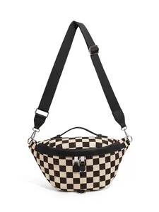 Macro detail of checkerboard canvas chest bag with silver zippers and black trim