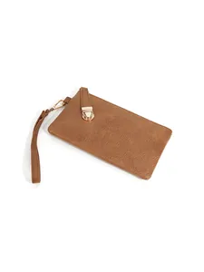 Detail of brown litchi texture on wristlet wallet with gold metal hardware and strap