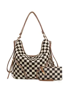Detail of checkered canvas hobo bag set with brown leather trim and side zipper