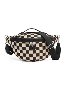 Detail of checkerboard canvas chest bag with silver zippers and black leather trim