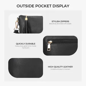 Detail view of black leather messenger bag featuring golden stylish zippers and tassels