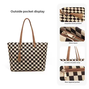 Checkerboard canvas tote bag with brown leather straps and metal zipper detail