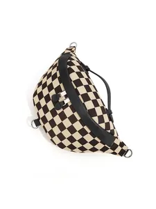 Detail of checkered canvas waist bag featuring dual zippers and silver D-ring accents