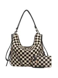 Close-up of checkerboard hobo bag with matching wristlet and decorative side zippers