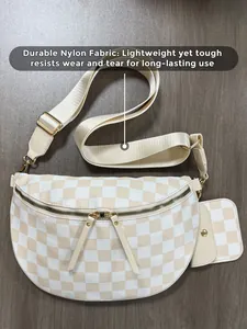 Detail of checkered nylon fanny pack showing durable fabric and gold metal zippers