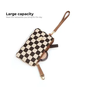 Classic checkered wristlet clutch with brown leather strap and spacious interior