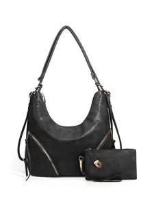 Macro shot of black pebbled PU leather hobo bag with golden hardware and small pouch