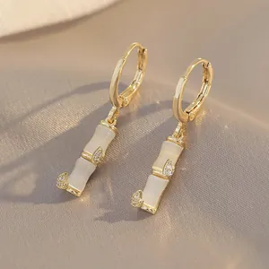 Bamboo-style opal hoop earrings in gold with sparkling diamond accents for women