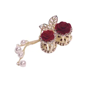 Elegant gold metal hair claw clip with red velvet roses, rhinestones, and pearl tassels