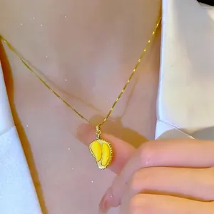 Fashionable golden durian pendant necklace with enamel detail on a delicate Chopin chain