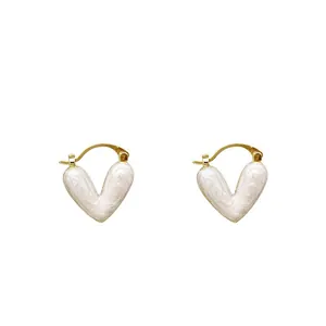 Elegant gold heart earrings with white enamel finish and French minimalist style