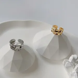 Detailansicht der gold- und silberfarbenen Ringe mit unregelmäßiger Wasserwellenstruktur