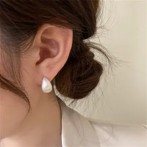 Close-up of a high-quality water drop pearl earring on model for an elegant vintage style