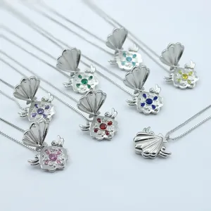 Macro detail of openable shell locket necklace with seven colorful rhinestones