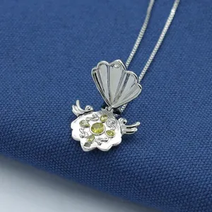 Anime shell pendant necklace in silver with opening lid and yellow gemstone core