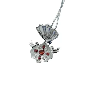 Silver shell locket necklace with red gemstone inlay and intricate inner relief