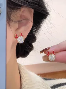 Detail of reindeer stud earrings with red enamel antlers and sparkling zircon stones