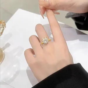 Close-up of gold ring with large round zircon and deer antler accent on a woman hand